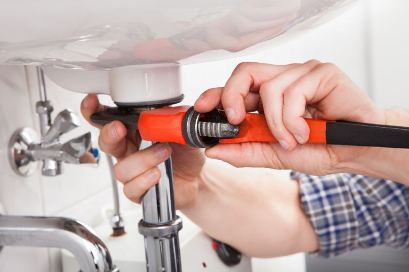 plumber-near-me-fixing-a-sink-in-bathroom-min
